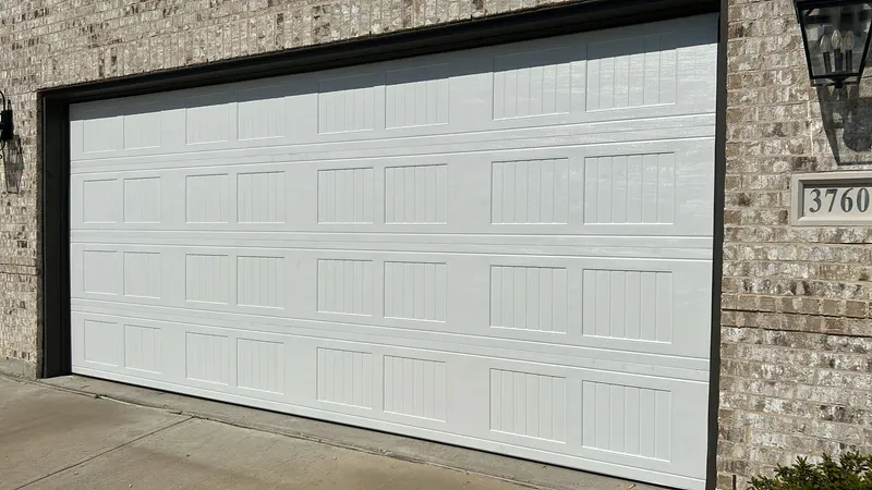 White raised-panel garage door on a brick home in the Dallas-Fort Worth metro