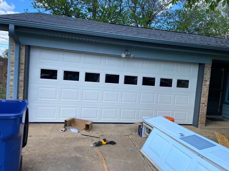 White garage door with a row of windows freshly installed on a DFW home